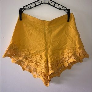 yellow flowy shorts with lace detailing